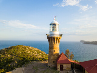 Hill top of Barrenjoey head of Sydney Pacific coast with the lighthouse overlooking palm beach on a sunny day.