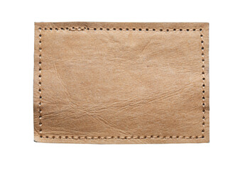 Blank brown leather label on white background, macro close up. Synthetic leather patch with...