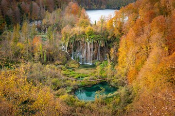 View of one of the biggest cascades of Plitvice Lakes National Park. Waterfall in the beautiful colored autumnal forest.