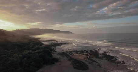 Cinematic sunrise with waves at beach in Costa Rica