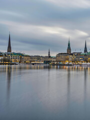 Fototapeta na wymiar Hamburg city centre on lake Binnenalster after sunset with street lights, Germany