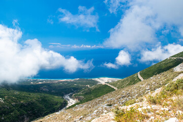 White fog high in mountains on Llogara pass. View from highlands on serpentine road to pass.Landscape of Albanian Riviera,