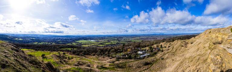 Fototapeta na wymiar Panoramic shot from Cleeve Hill looking towards Cheltenham and Gloucester, Gloucestershire.