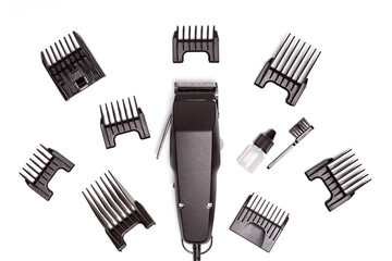 Professional hair clipper with set of nozzles of different sizes isolated on white background. Top view