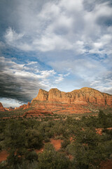 Sunset view of red rock buttes and formations within coconino national forest in Sedona Arizona USA against white cloud background. Horizontal Image.