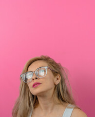 beautiful woman wearing stylish glasses with a pink background and white blouse, casual with glasses