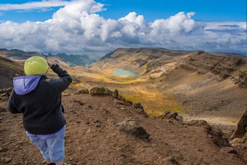 Foto op Canvas A tourist looking at Wildhorse canyon and lake, near the summit of the steens mountains near Frenchglen, Oregon © Bob