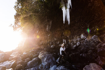 Young woman outdoor, winter, giant icicle, winter, coastline, Vancouver Island, ecotourism