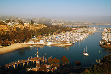 An aerial view from a high cliff gives a splendid view of the marina and harbor of Dana Point, along the Southern California coast - obrazy, fototapety, plakaty