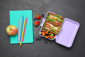 Flat lay composition with lunch box of tasty healthy food and school stationery on grey table