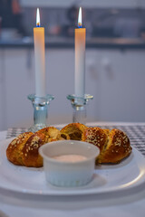 Shabbat image. Challah bread and candles and salt on the table