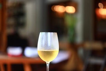 a glass of white wine in a restaurant, alcohol luxury background