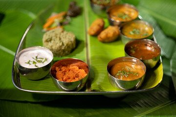 A meal plate ('bhojanam') with a variety of vegetarian dishes from the Andhra region of southern Indian, including fried potato dumplings ('aloo bajji') and spiced rice ('donne biryani').