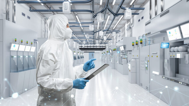 Worker or engineer wears protective suit or coverall suit work in semiconductor manufacturing factory
