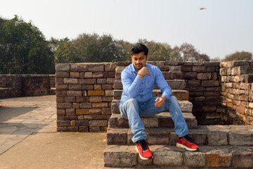 Male model with blue denim clothes posing for photographs 