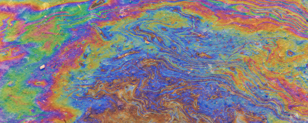 Fototapeta na wymiar spilled gasoline rainbow background, industrial hazard spill pollution, abstract texture multicolored