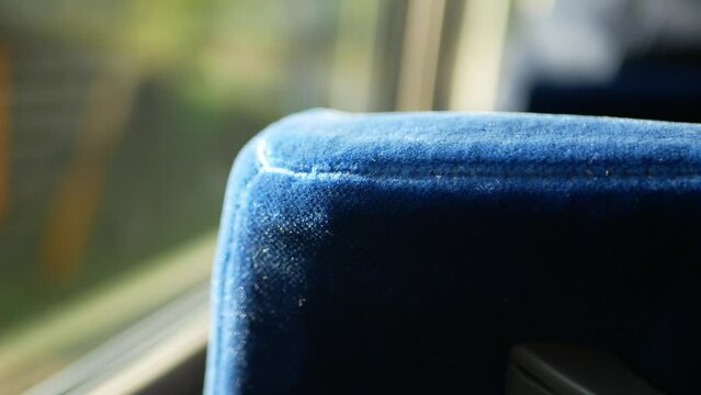 selective focusing view to the seat on the bus while moving up to mountain range hill with sunlight shine through the window