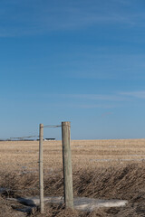 Fence posts with wire around a farm in Alberta