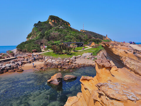 Many tourists visit the popular attraction with strange shape stone at Yehliu Geopark in Wanli District, New Taipei, Taiwan. These rock eroded by wind and sea waves to form a fascinating landscape.