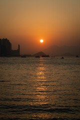 Naklejka premium Sunset, a view from the Kowloon side. Fantastic weather, but the view was hazy as the air getting polluted. 