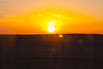 Beautiful sunset on salt lake Chott el Djerid, Sahara desert, Tu
