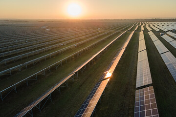 Aerial view of big sustainable electric power plant with many rows of solar photovoltaic panels for...