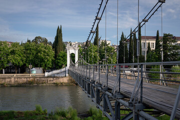 View of the suspended pedestrian bridge over the Sochi River on a sunny summer day, Sochi, Russia