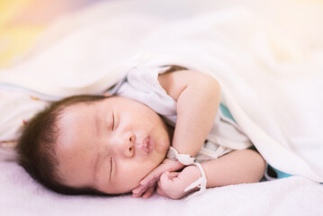 sleeping newborn baby boy asian