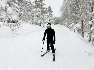 Fototapeta na wymiar Female skier standing on the slope