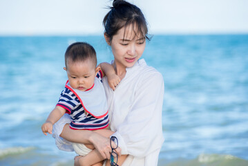 baby and mother on the beach