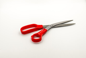 Open scissors with red handles