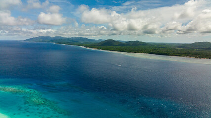 Aerial view of coast of a tropical island covered with forest. Balabac, Palawan. Philippines.