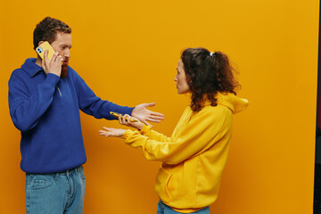 Woman man cheerful couple with phones in hand social networking and communication crooked smile fun...