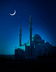 Beautiful mosque illuminated in the soothing blue moonlight. A Ramadan moon and the mosque. Photo of crescent for the occasion of Eid ul fitr.