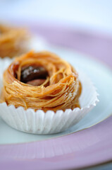 Bird's nest - a Mediterranean sweet presented in a paper cups. Extreme closeup of Turkish dessert.