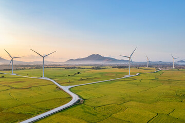 Panoramic view of wind farm or wind park, with high wind turbines for generation electricity with...