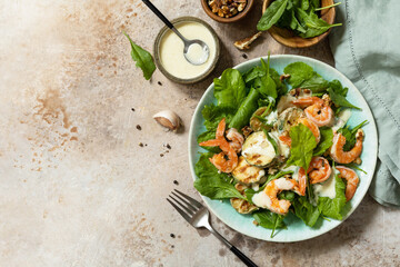 Healthy food concept. Vegetarian vegetable low carb lunch bowl. Diet salad shrimps with arugula, grilled zucchini and walnut. View from above. Copy space.