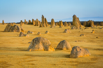 Landscape with jagged limestone pillars at sunrise in the Pinnacles Desert of Western Australia