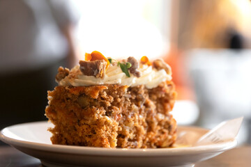 Carrot cake with walnuts, prunes and dried apricots with little edible flower.