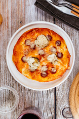 homemade pizza with sausages, cheese and vegetables
