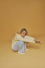 Young freckles woman wearing a yellow sweatshirt