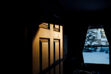 Light and Shadows on Bedroom Door in Small Home in Winter