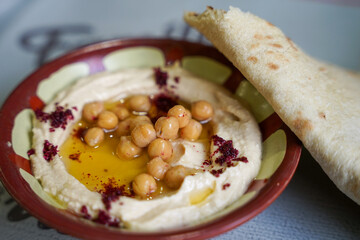 Hummus, delicious arab vegan spread or dip made from chickpeas and sesame, served with arab bread