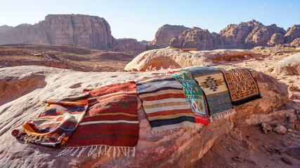Colourful handmade bedouin rugs on stone, Petra, Jordan