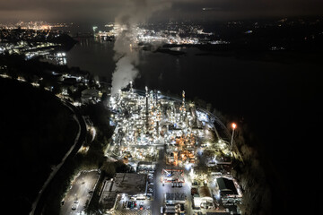Oil refinery aerial view at night, hyper lapse, distillation tower, gas production, smoke stack,...