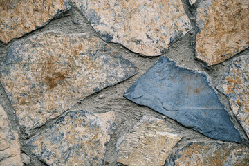 A piece of masonry wall made of natural stone to protect the city, residences and other structures.