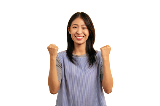 Young asian woman in casual clothes smiling and raising fists to making winner's gesture to celebration with rejoicing isolated