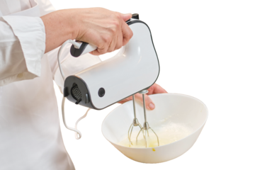 An adult woman in white chef's clothes cooks food in a home kitchen, isolated on a white background