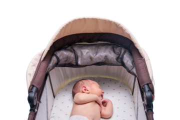 Baby boy in a carriage, isolated on a white background. A child in white clothes in only diapers is lying in a stroller, studio shot