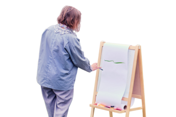 Happy woman draws on the easel with a brush and paints, isolated on a white background. Woman artist draws nature and trees on paper by the water on the river bank